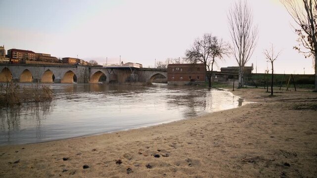 Medieval stone bridge spanning the Duero River in Tordesillas, Spain