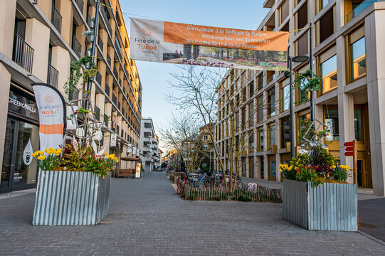 MORGES, VAUD CANTON, SWITZERLAND - APRIL 09 2026: Welcome banner for the annual Tulip Festival displayed above a pedestrian street decorated with flowers in the city center in Switzerland.