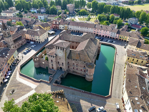 Aerial view of Fontanellato Castle and its water-filled moat surrounded by historic buildings in Fontanellato, Emilia-Romagna, Italy.