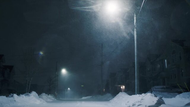 A powerful snowstorm sweeps through Beachville, Nova Scotia, creating heavy drifts and blocking streets under a blanket of white. The howling wind brings a surreal winter atmosphere to the night