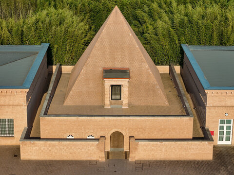 Fontanellato, Italy - 26 May 2026: Aerial view of Labirinto della Masone, featuring the brick pyramid chapel surrounded by lush bamboo groves under soft daylight.