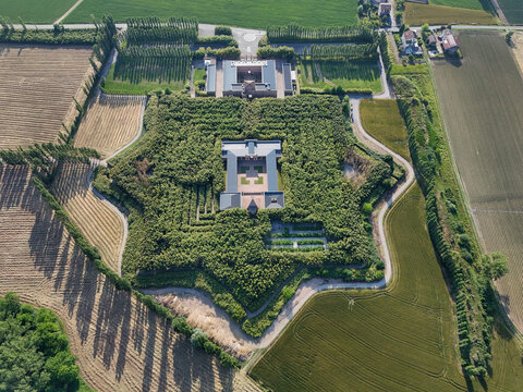 Fontanellato, Italy - 26 May 2026: Aerial view of Labirinto della Masone, a star-shaped bamboo maze surrounded by lush green fields and agricultural land.