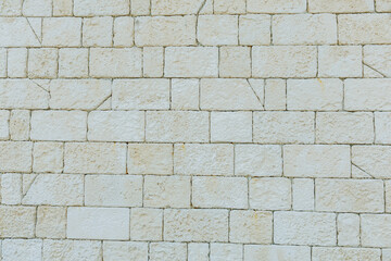 Fototapeta premium Simple yet stylish limestone pattern suitable for various displays and art. Consistent limestone wall surface offers subtle textured background for signage and artistic endeavors