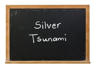Fototapeta premium Silver Tsunami written in white chalk on a black chalkboard isolated in a wooden frame on white