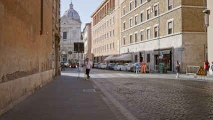 Naklejka premium Defocused city street scene with shallow bokeh over cobblestone pavement and distant church dome, soft street; backplate template overlay.