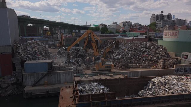 cranes move metal in scrapyard in Gowanus Brooklyn
