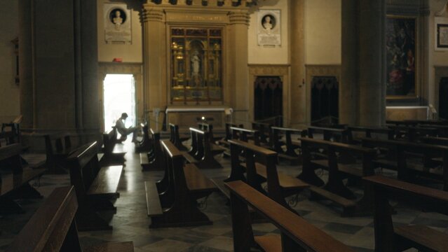 Shallow blurred church interior with wooden pews, marble floor and distant altar; background backplate copyspace calm.