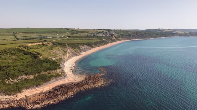 Aerial drone footage of Redcliff Point on the Dorset coast, showcasing striking coastal cliffs, rugged shoreline, and panoramic views of the English Channel
