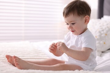Fototapeta premium Cute little baby boy on bed at home. Space for text