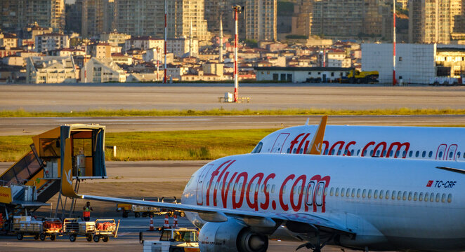 Close up side profile of a Pegasus Airlines fuselage during ground service operations