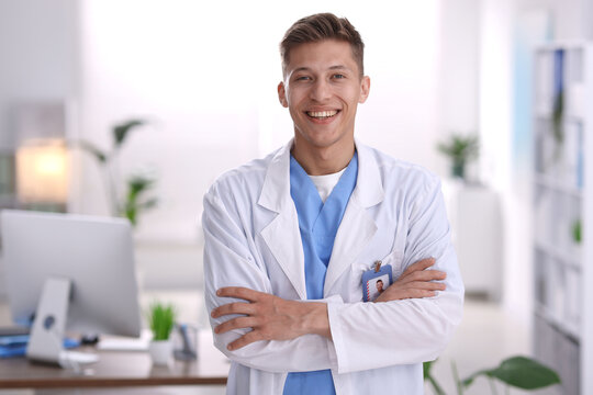 Portrait of medical assistant in white coat at clinic