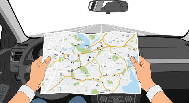 A driver holds a detailed navigation map while steering a vehicle along a long, open road seen through the front windshield of the car cabin.