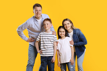 Fototapeta premium Portrait of happy family on yellow background