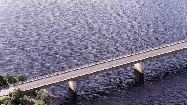 Cars on Lyell highway Bradshaw bridge in Tasmania crossing Lake Burbury travel.