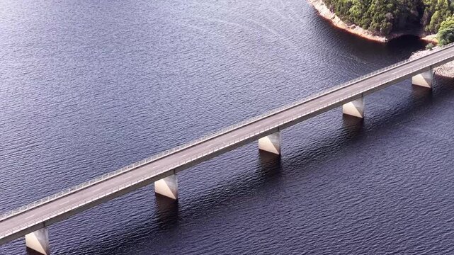 Close aerial view of Bradshaw bridge across Burbury lake in Tasmania &ndash; Lyell highway traffic.