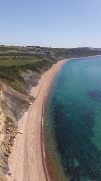 Aerial drone footage of Redcliff Point on the Dorset coast, showcasing striking coastal cliffs, rugged shoreline, and panoramic views of the English Channel