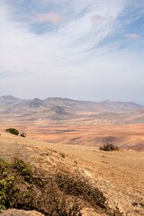 Naklejka premium Wide view of Lanzarote desert landscape with volcanic hills and stark island beauty