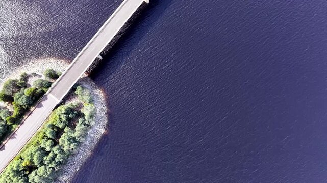 Lift vertical aerial panorama over Bradshaw bridge Burbury lake in Tasmania Lyell highway.