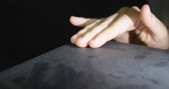 Finger Wiping Heavy Dust from Surface Close Up