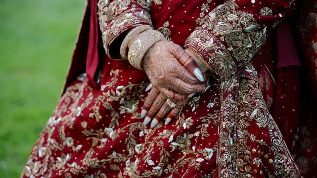 Traditional Indian bridal dress with elegant embroidery, mehndi hands, jewelry, and luxury wedding fashion details during cultural ceremony celebration.