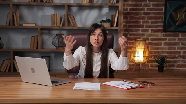 Business woman argues and throws papers during a meeting in an office setting.