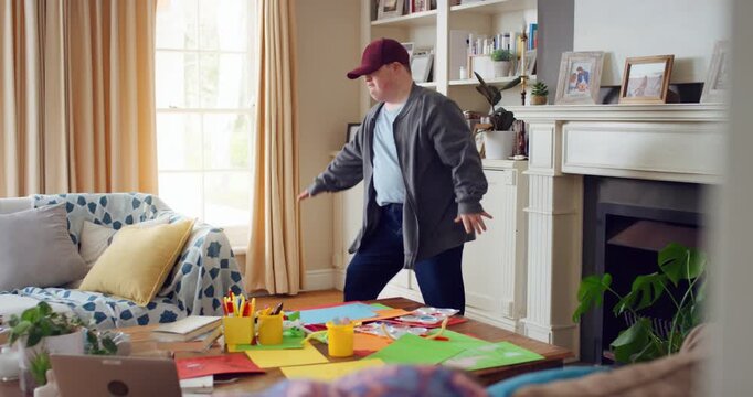 Cap, dancing and man with down syndrome in living room, practice performance and music for rhythm. Weekend celebration, hat trick and person with singing for expression, entertainment and fun in home
