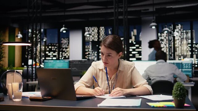 Frustrated entrepreneur ripping torn paper after finding bad typo in her research notes, at night in modern workspace. Businesswoman faces stress from overtime work, reflecting disappointment.