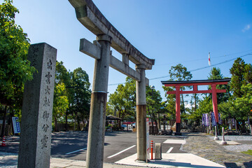 Naklejka premium Stone Torii of Ogaki Hachiman Shrine, this shinto shrine rebuilt in the 1950s ,with orange red torii on the back