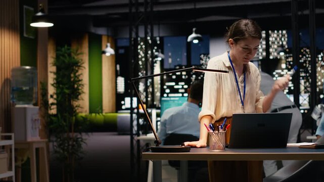Completing spreadsheets on laptop, employee inputting and analyzing data. Woman researching information online and typing information to align with business intel and objectives.