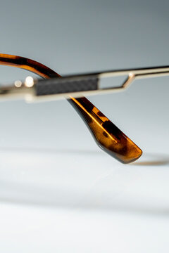 Eyewear arm featuring tortoise shell pattern and metal details