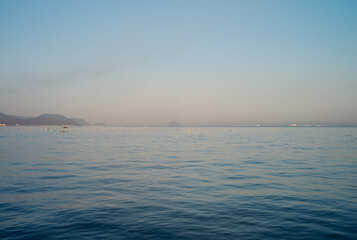 Obraz premium Serene morning sea landscape with distant island silhouettes in Seto Inland Sea near Naoshima Japan after color correction