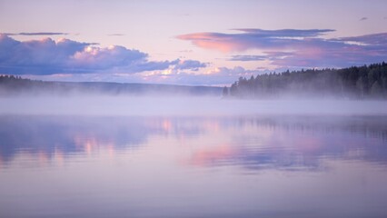 Fototapeta premium Misty Lake at Dawn with Forest Reflection
