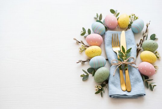 Easter Holiday Menu Table Setting With Colorful Eggs and Cutlery