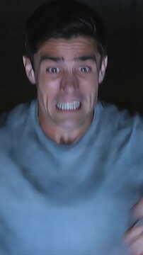 Man Watching Tv at Night with a Concerned Expression