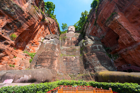 Low angle view of the majestic Leshan Giant Buddha sitting carved into the sandstone cliff face in Sichuan, China