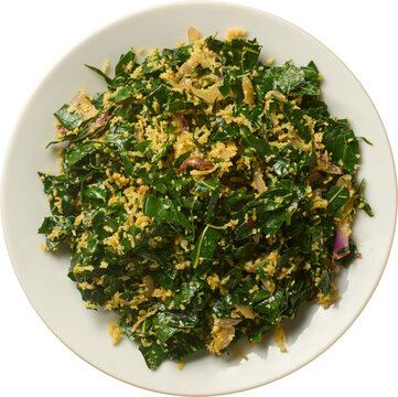 cooked murunga leaves side dish on plate isolated white background, traditional food mixed with grated coconut top view
