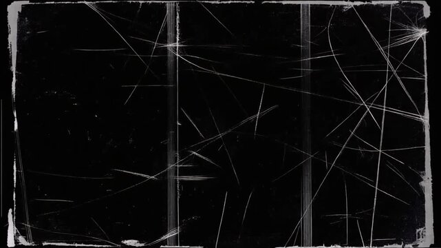 Static video footage of a black background with white scratches and marks. Close-up view of a scratched surface with visible lines and imperfections.