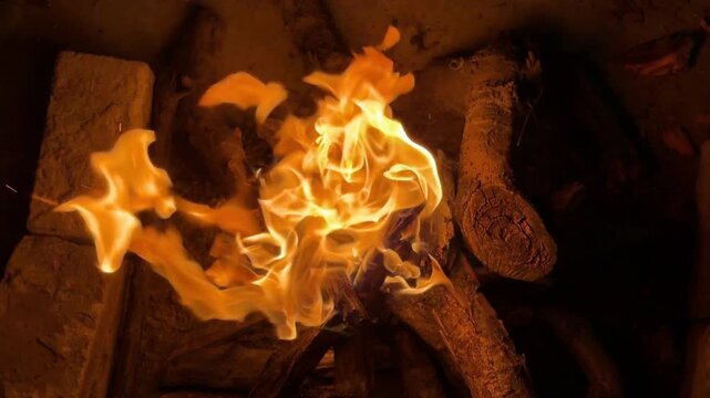 Glowing fire close‑up while celebrating Eid with barbecue outdoors.