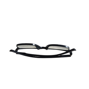 Black eyeglasses with green temples on a plain surface