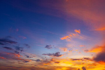 Fototapeta premium Beautiful dramatic sunset sky with vibrant clouds and gradient colors,A breathtaking panoramic view of a dramatic sunset sky filled with vibrant orange, yellow, and blue clouds, perfect for nature.