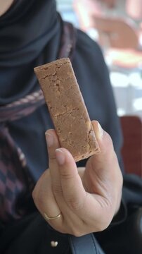 Close-up of a Hand Holding a Protein Snack Bar