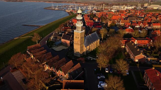 Aerial view of Grote Kerk church tower and red rooftops in Hindeloopen, Friesland, Netherlands.