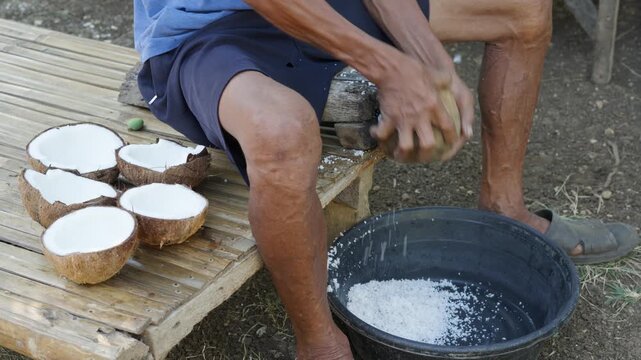 Filipino Grating Coconut for Mixing with Cassava Suman in Cebu Province Philippines