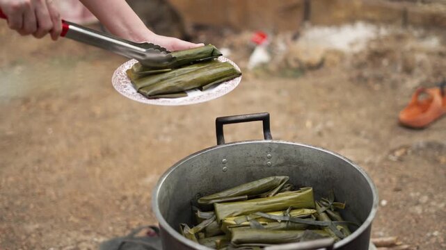 Filipino Taking Cooked Cassava Suman from Large Pot in Cebu Province Philippines