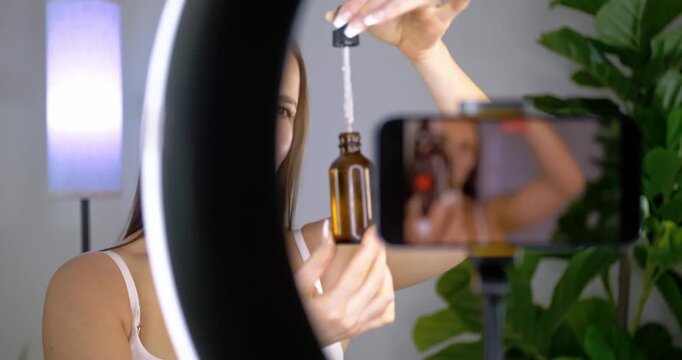 Influencer Applies Serum During Beauty Tutorial at Home Studio