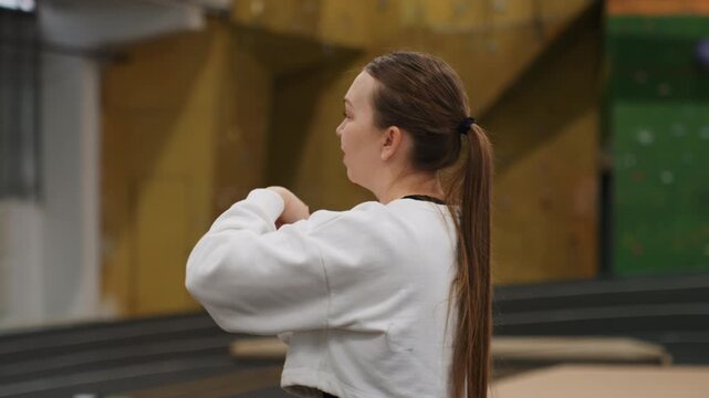Caucasian female athlete. Player preparing precise serve with proper wrist and arm position. Female athlete from Caucasian background setting up accurate serve with focused posture and alignment