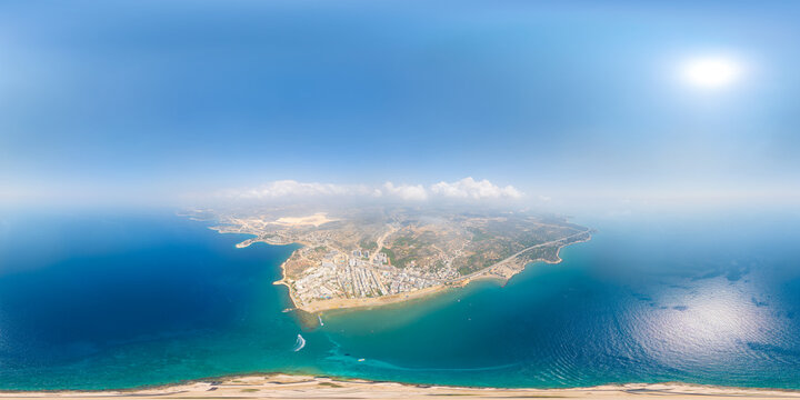 Kizkalesi, Mersin, Turkey. Maiden's Castle island fortress, complete spherical aerial panorama over turquoise Mediterranean waters, coastal town and distant Taurus Mountains under bright summer sun