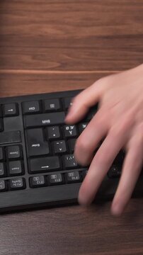 Frustrated hitting keyboard and throwing it off desk in home office