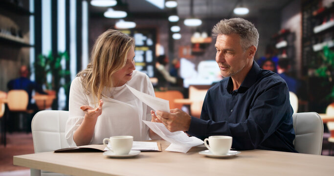 Corporate Compliance Officer Listens Intently As Woman Hands Confidential