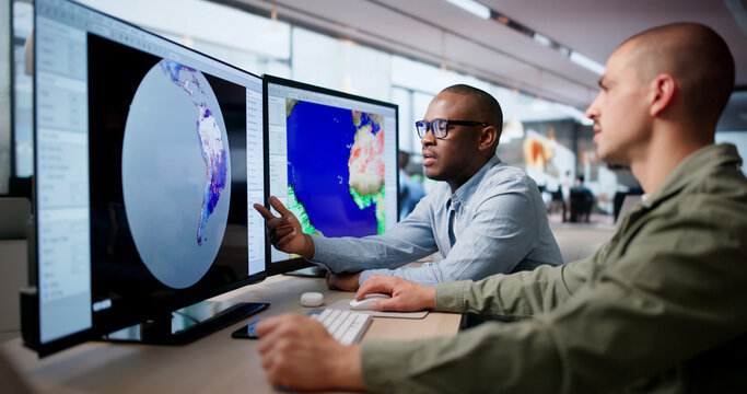 Two Meteorologists Use Computers